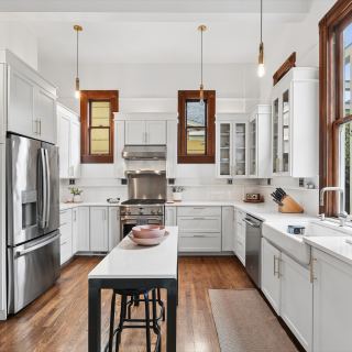 The remodeled kitchen: quartz counters and exposed brick