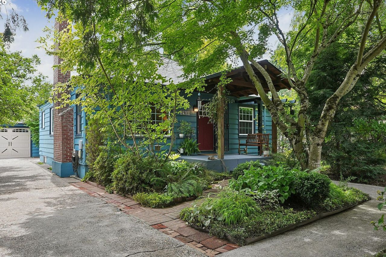 5900 NE Ainsworth Street, behind its gate on a quarter-acre.
